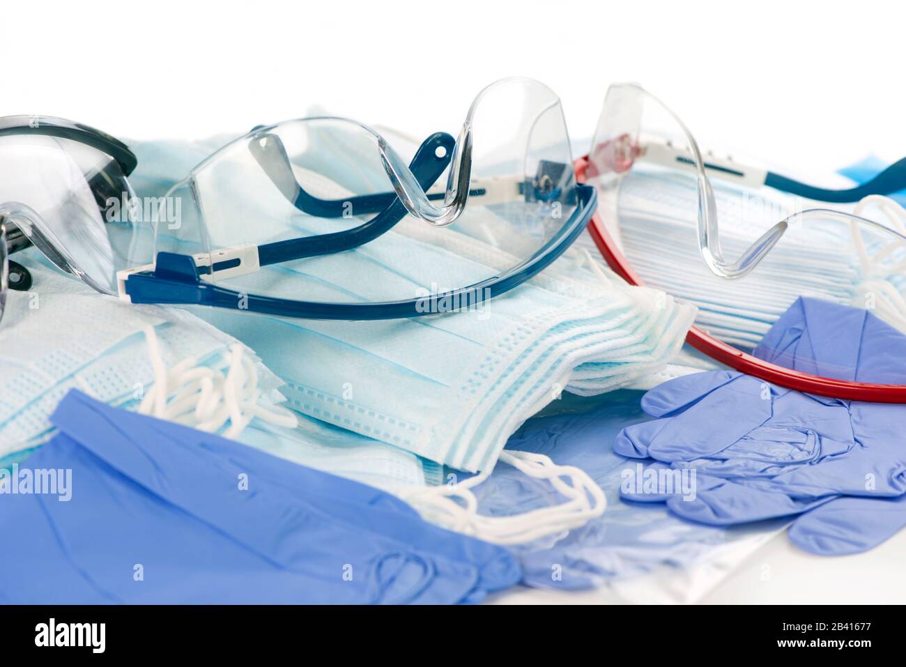 Personal protection equipment, safety glasses, many masks and nitrile gloves to prevent the spread of infection. Stock Photo