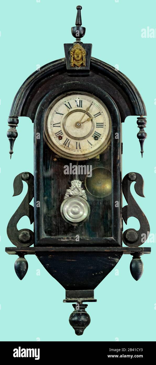 Antique swing wall clock. Pendulum clock on isolated green background