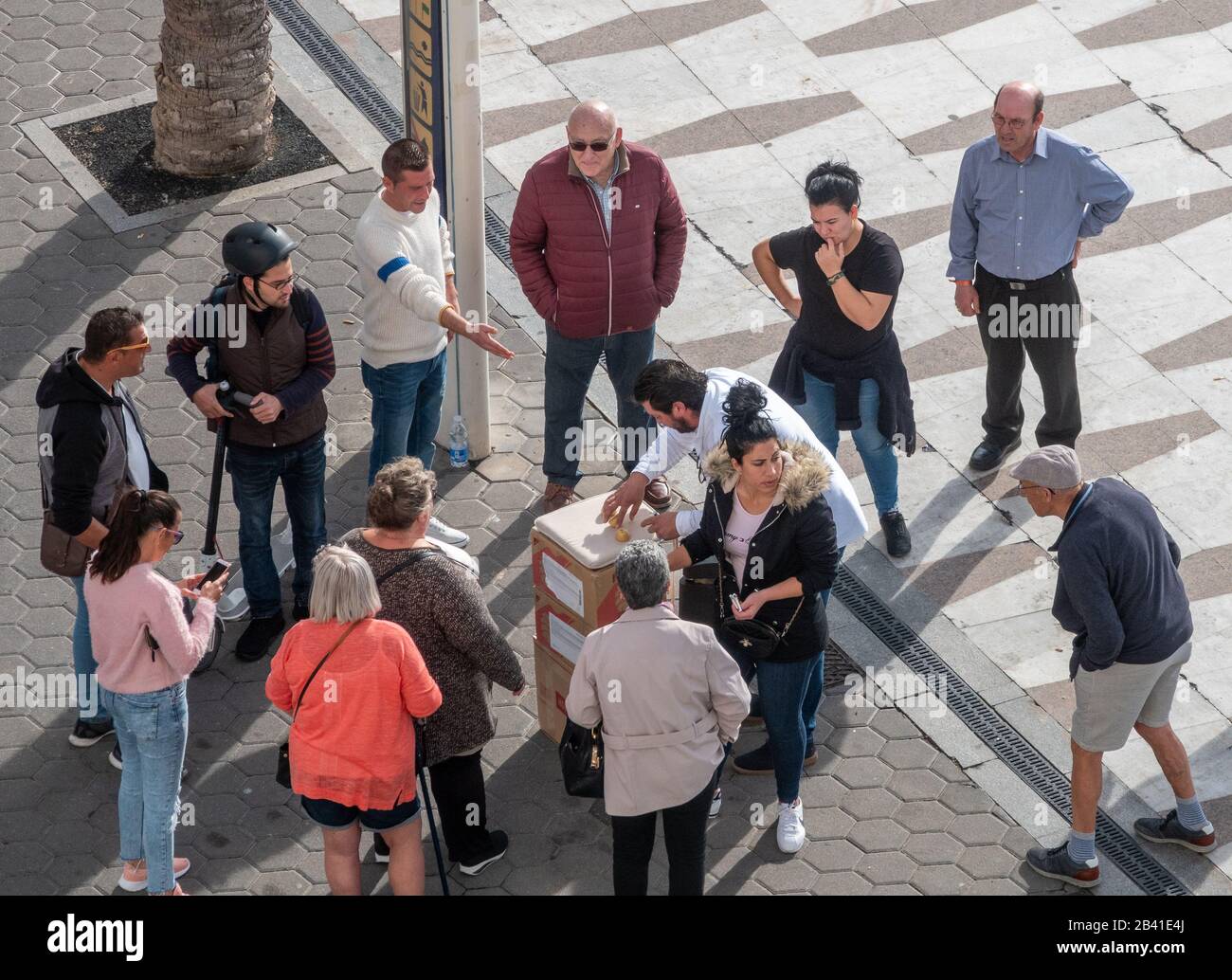 Three shell game, con artists on the city streets, all the people appear to be part of the scam aimed at gullible tourists. Stock Photo