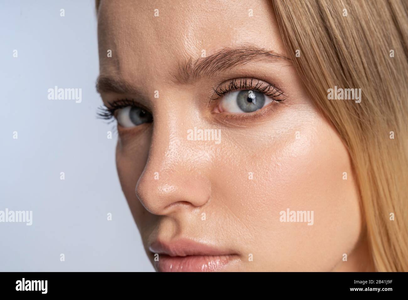 Pretty tranquil Caucasian young lady staring forward Stock Photo