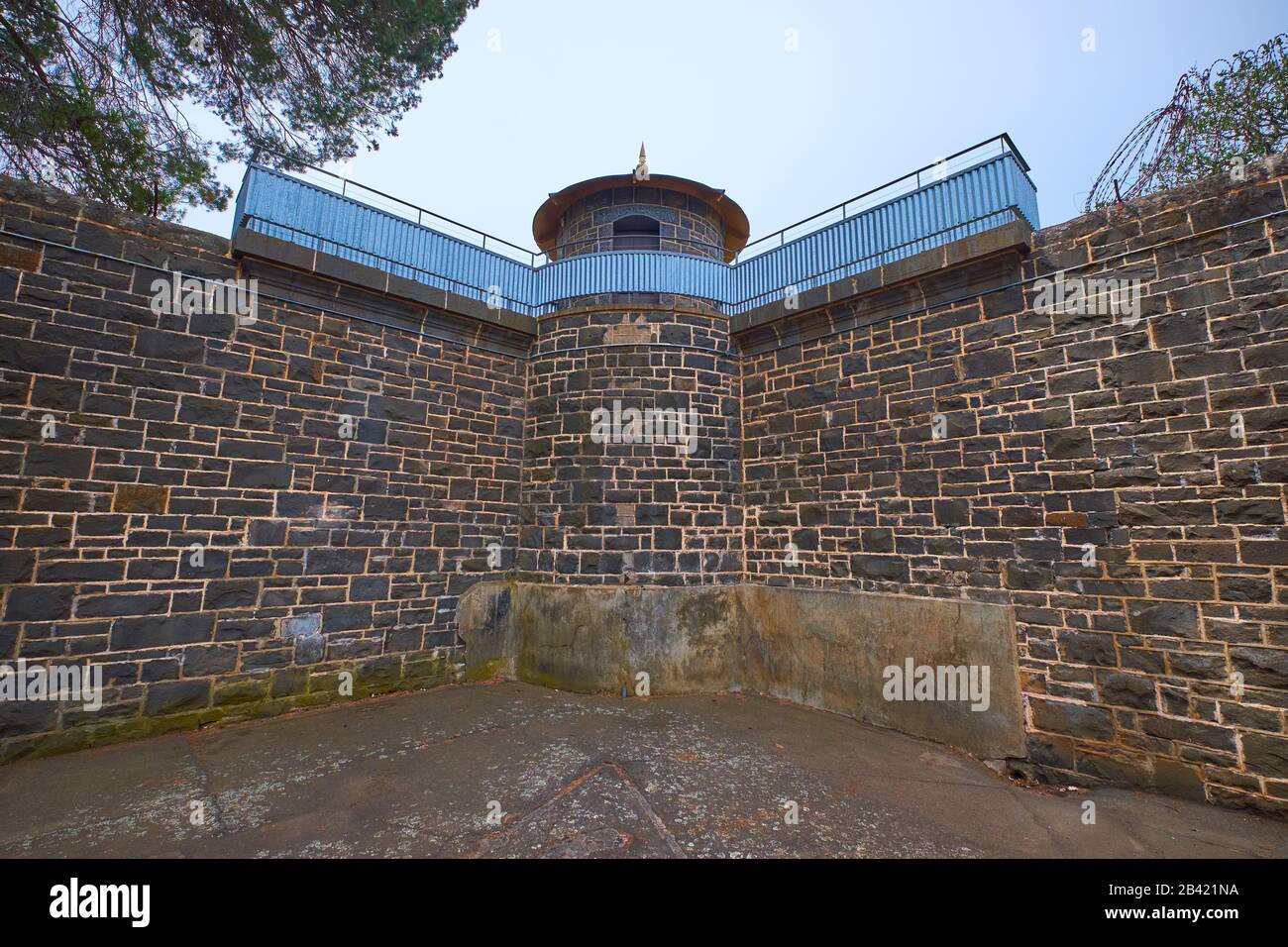 A corner security guard watchtower atop a stone wall at the J Ward goal