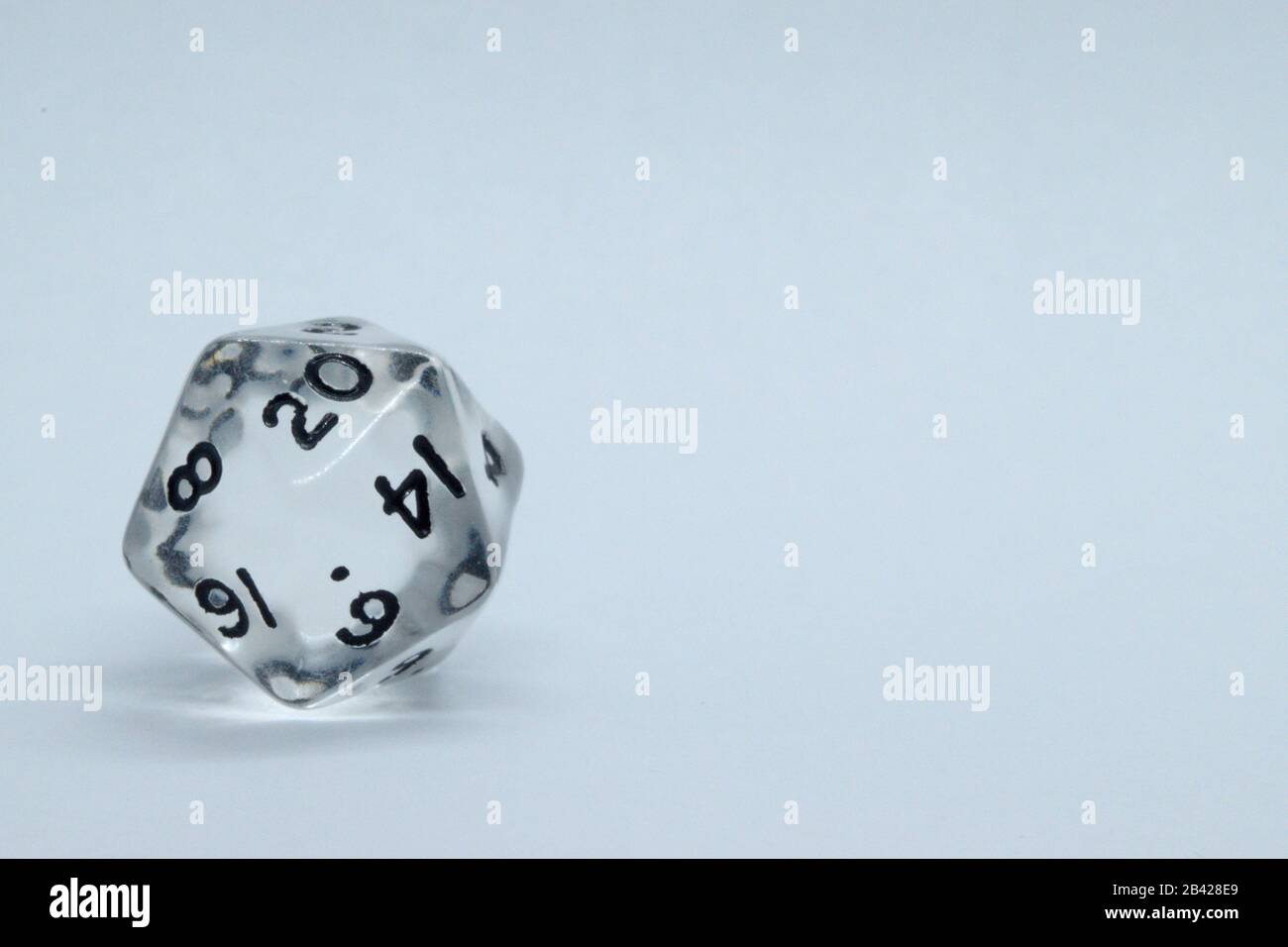 Isolated 20 sided die with white background. Dead space for text Stock Photo