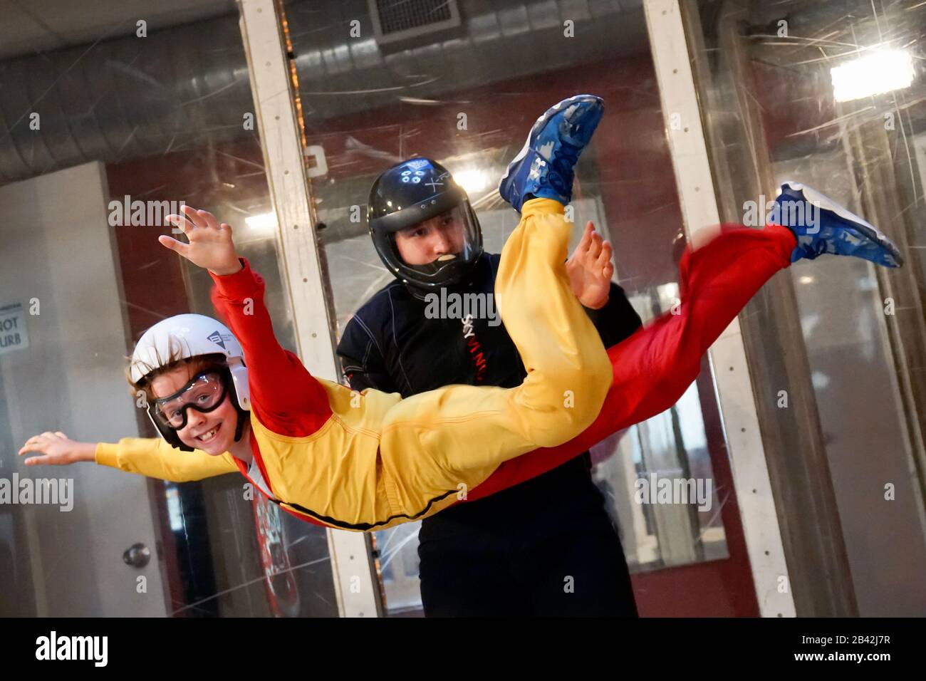 A boy smiles while indoor skydiving. Stock Photo