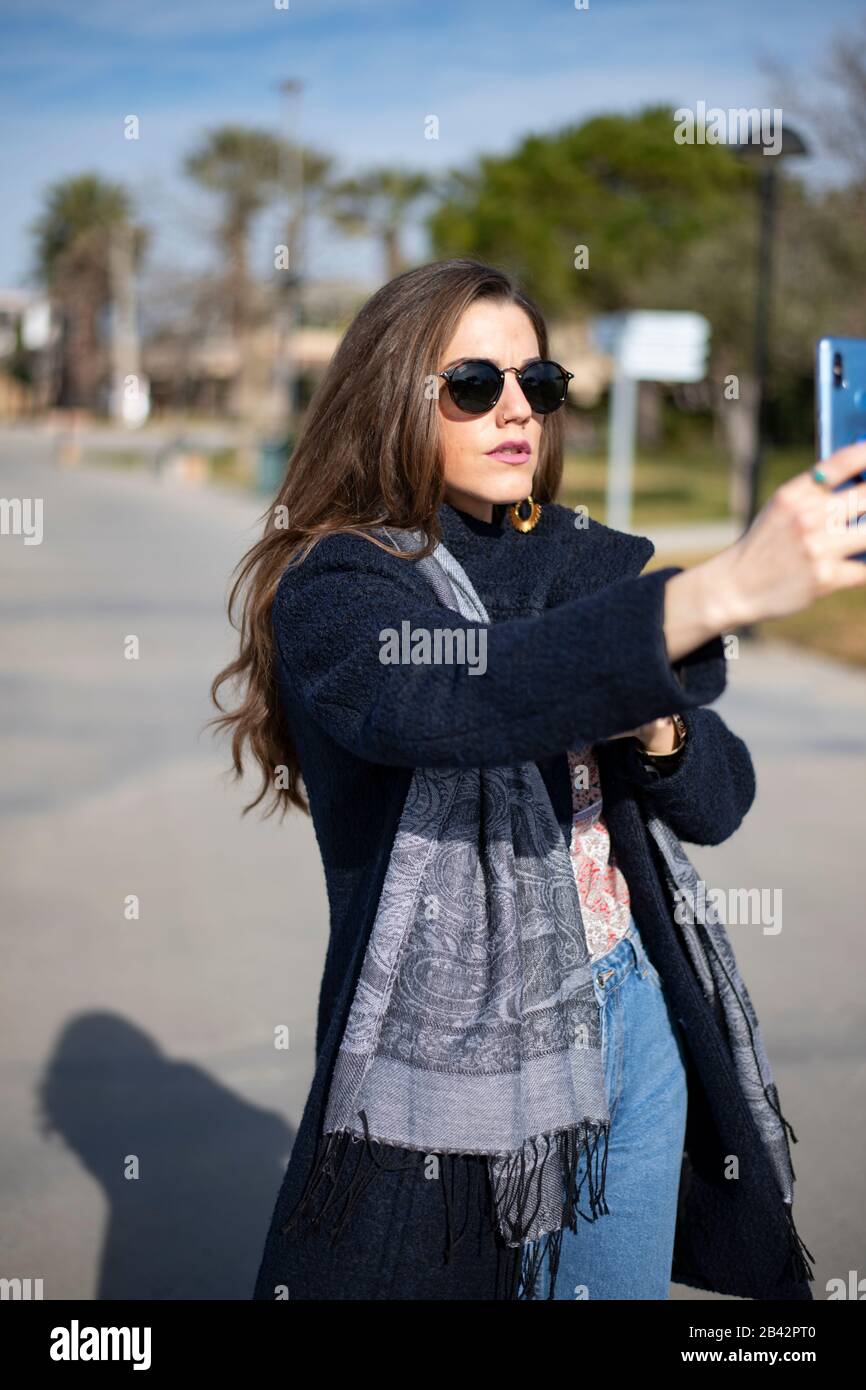 Business woman takes selfies in a warm winter day Stock Photo