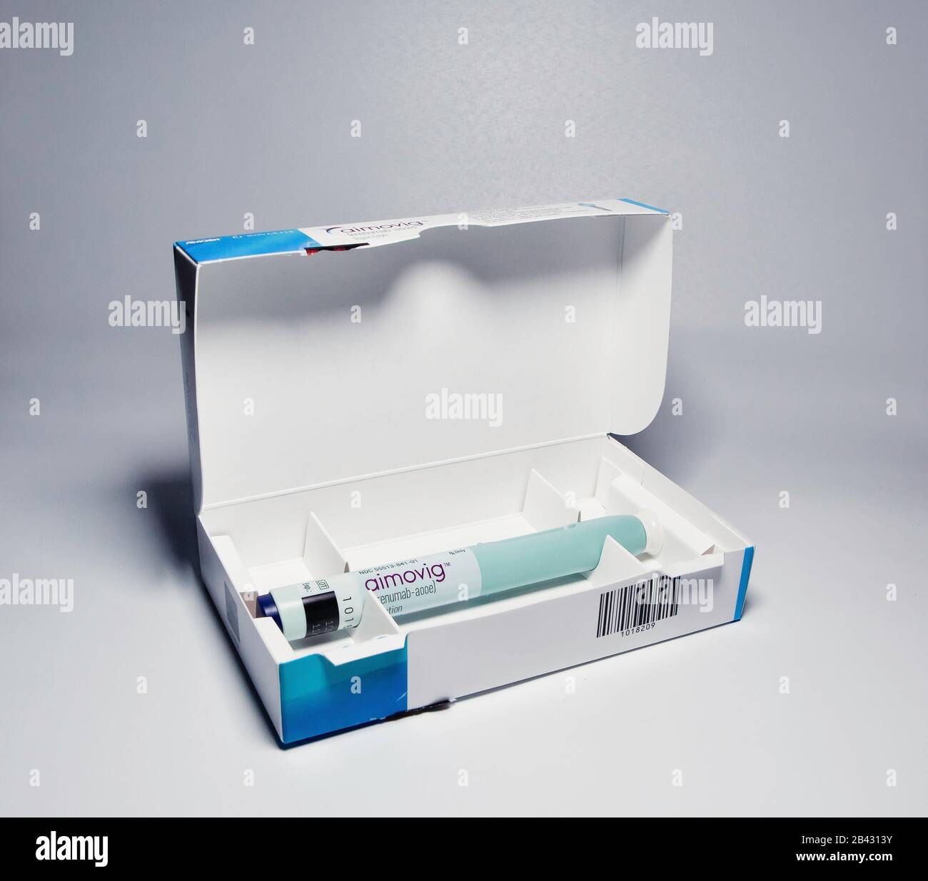 Aimovig (erenumab-aooe) 70 mg auto-injector device in box, prescription drug for migraine prevention, studio, color, United States Stock Photo