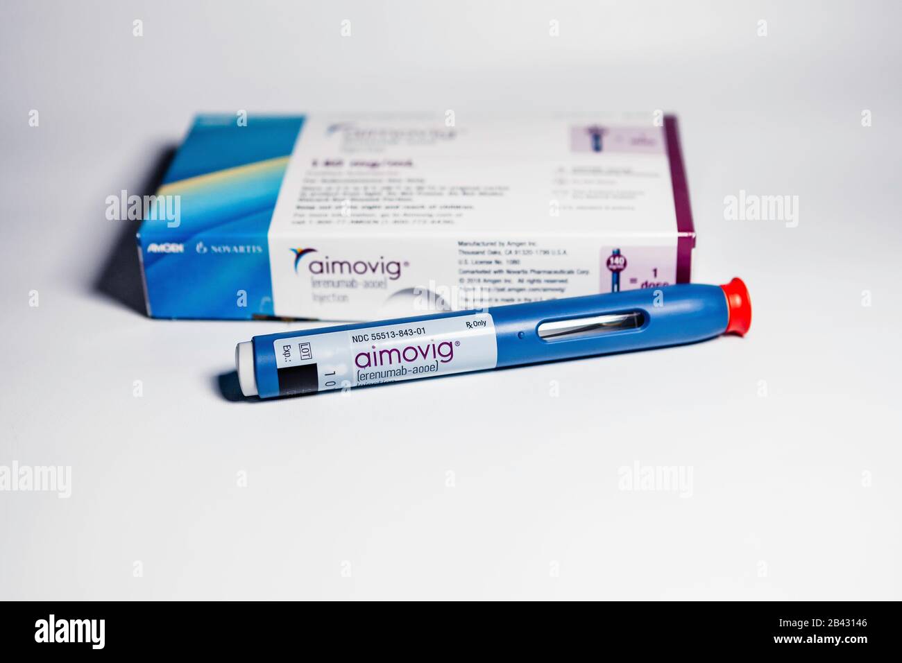 Aimovig (erenumab-aooe) 140 mg auto-injector device, prescription drug for migraine prevention, and box, studio, color, United States Stock Photo