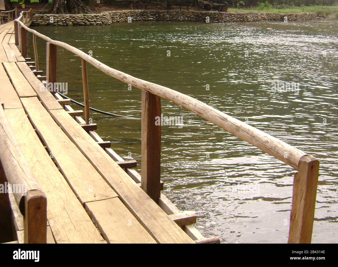 Wooden bridge with railing across Tinuy-an Falls, a top attraction in Surigao del Sur, Philippines. Stock Photo