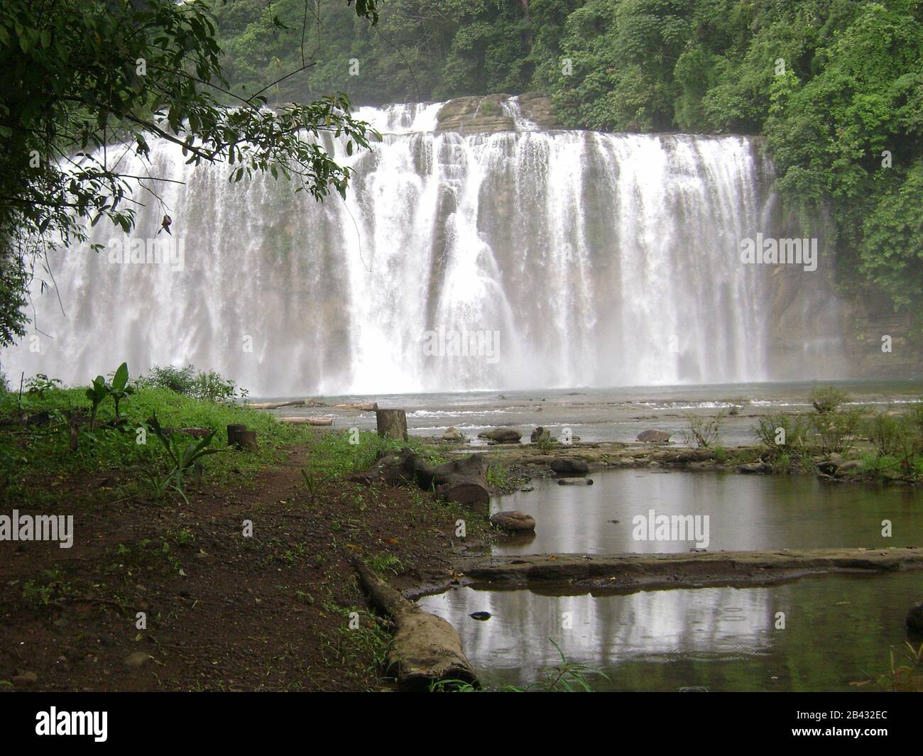 Tinuy-an Falls reflected in a pool of water. Tinuy-an Falls is a top attraction in Surigao del Sur, Philippines. Stock Photo