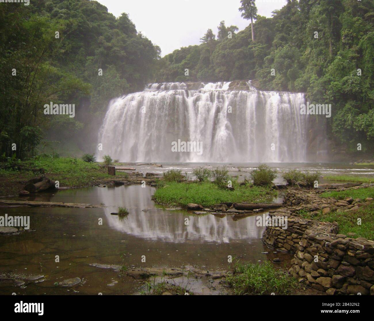 Tinuy-an Falls reflected in a pool  of water. Tinuy-an Falls is in Surigao del Sur, Philippines. Stock Photo