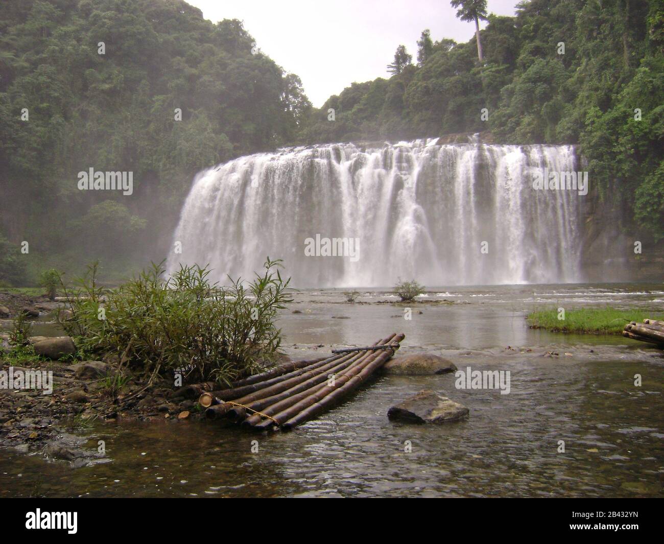 Tinuy-an Falls  with a bamboo raft in the water. Tinuy-an Falls is in Surigao del Sur, Philippines. Stock Photo