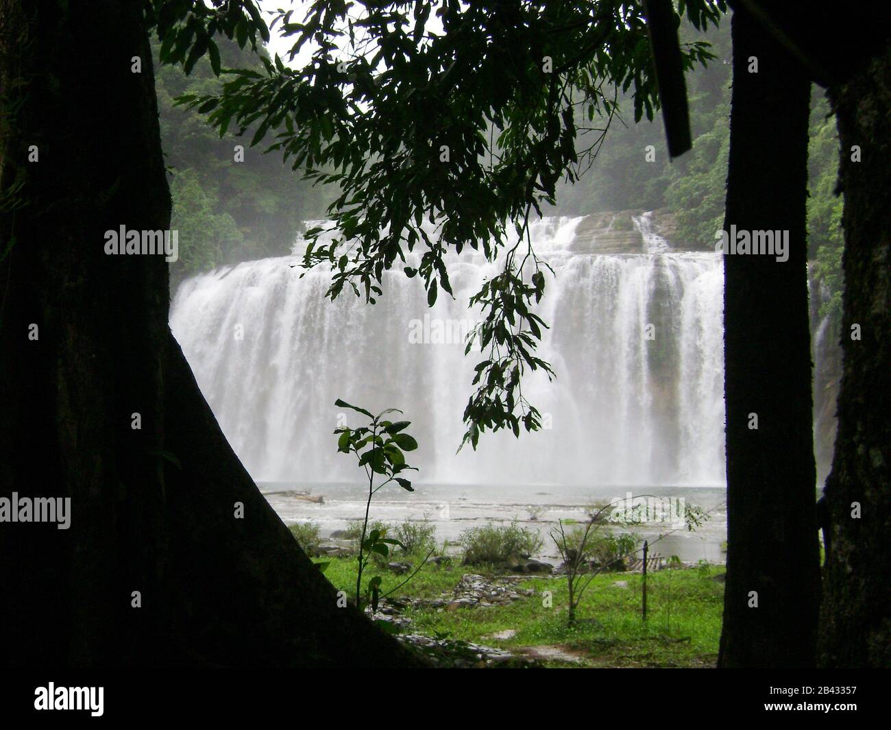 Silhouette of trees framing Tinuy-an Falls in Surigao del Sur, Philippines. Stock Photo