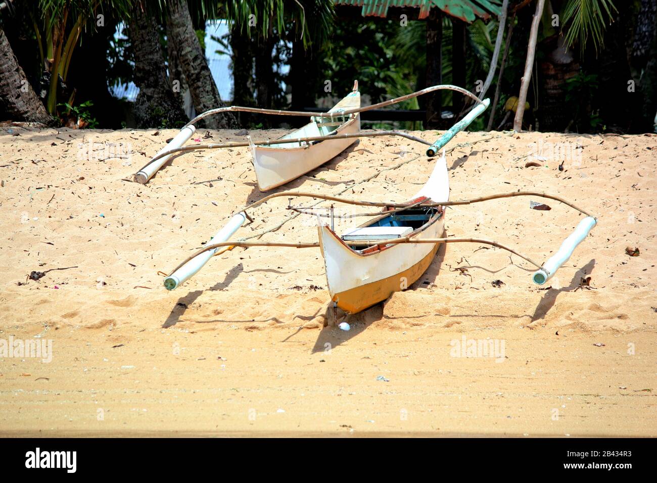 Outrigger boats on a white sand  beach  in Surigao del Sur, Philippines. Stock Photo