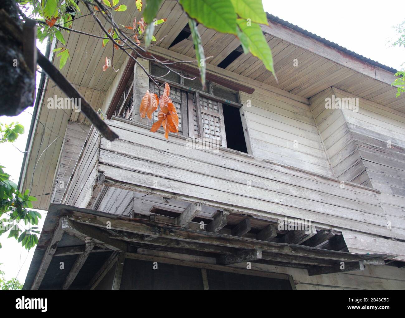 Upward shot of a dilapidated ancestral wooden house, southern Philippines. Stock Photo