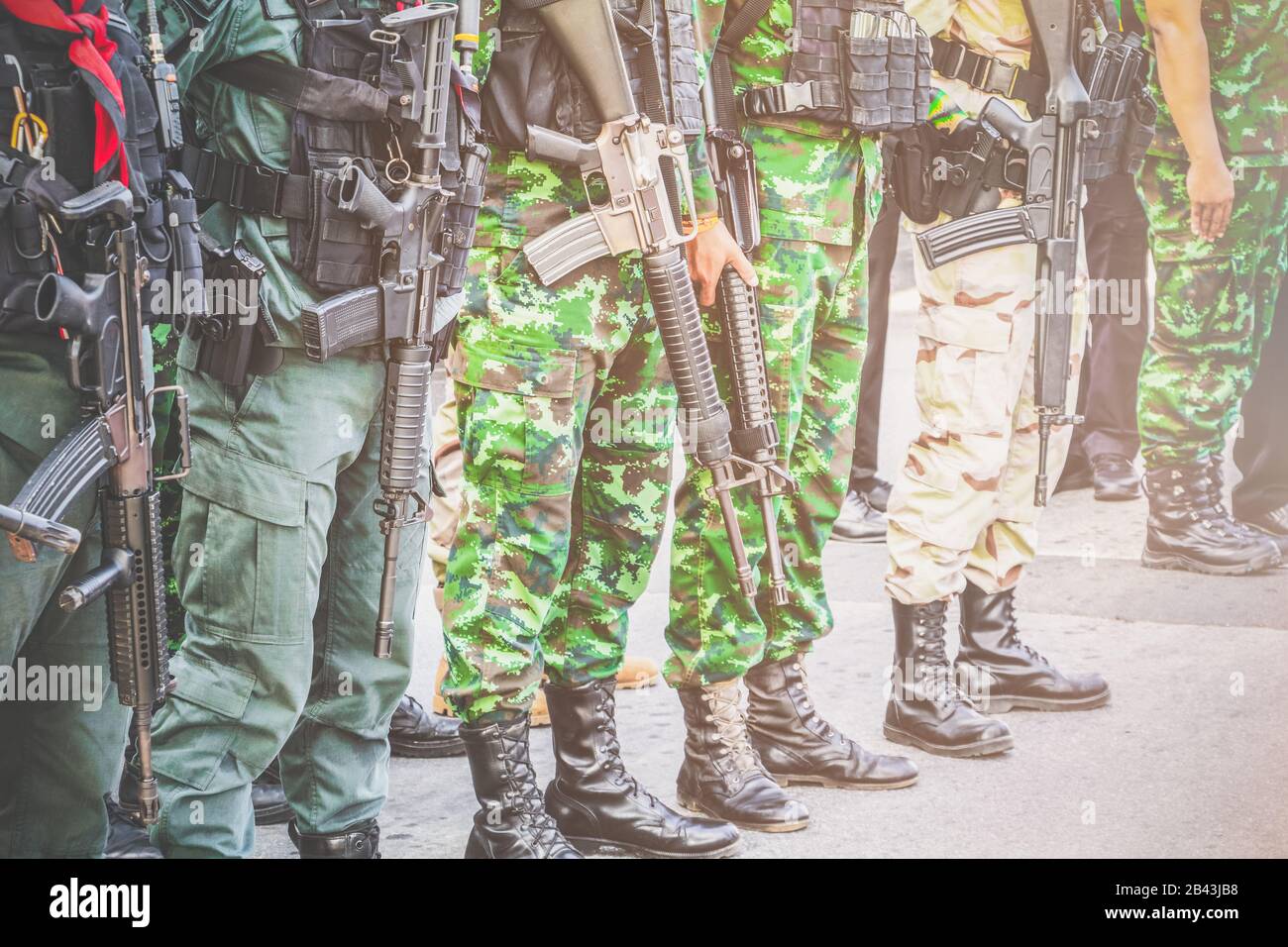 Soldier, commando standing, prepare for protection in row and hold gun in  hand. Vintage style Tone Stock Photo - Alamy