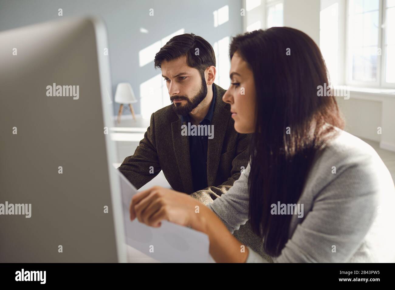 Business people partners team analyze discuss work statistics charts in computer at table at office Stock Photo