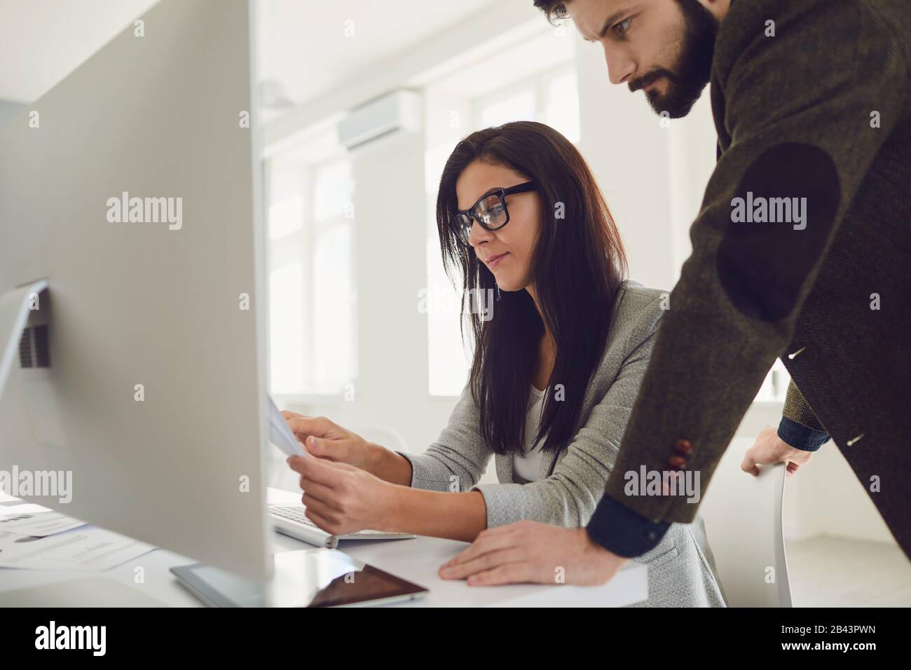 Business people smiling while standing in office. Stock Photo