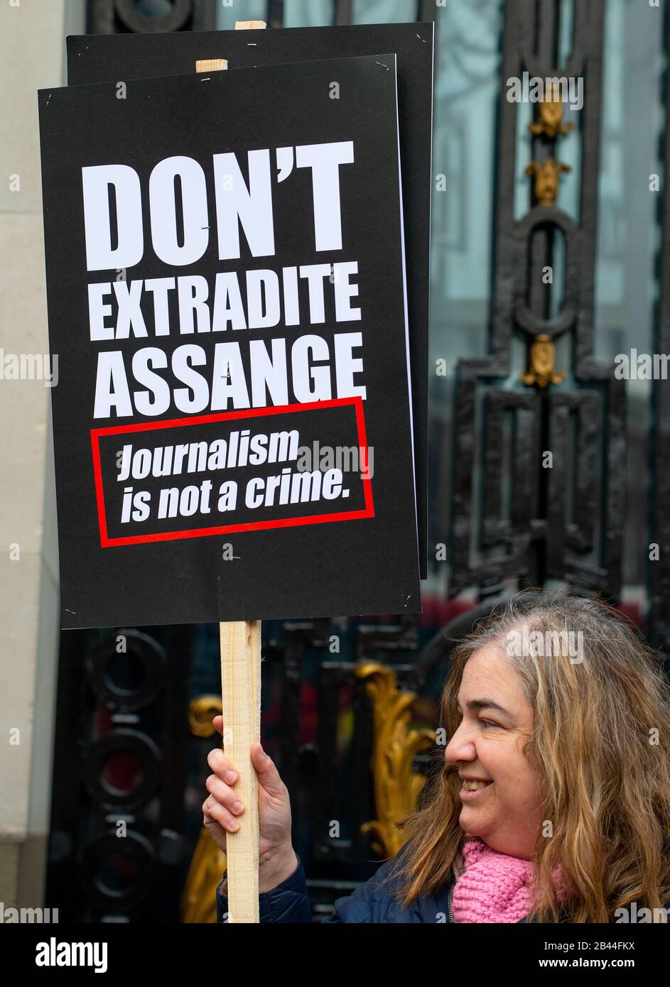 Protester with banner at the Don't Extradite Assange rally in The Strand, in protest of WikiLeaks founder Julian Assange's extradition to the USA. Stock Photo