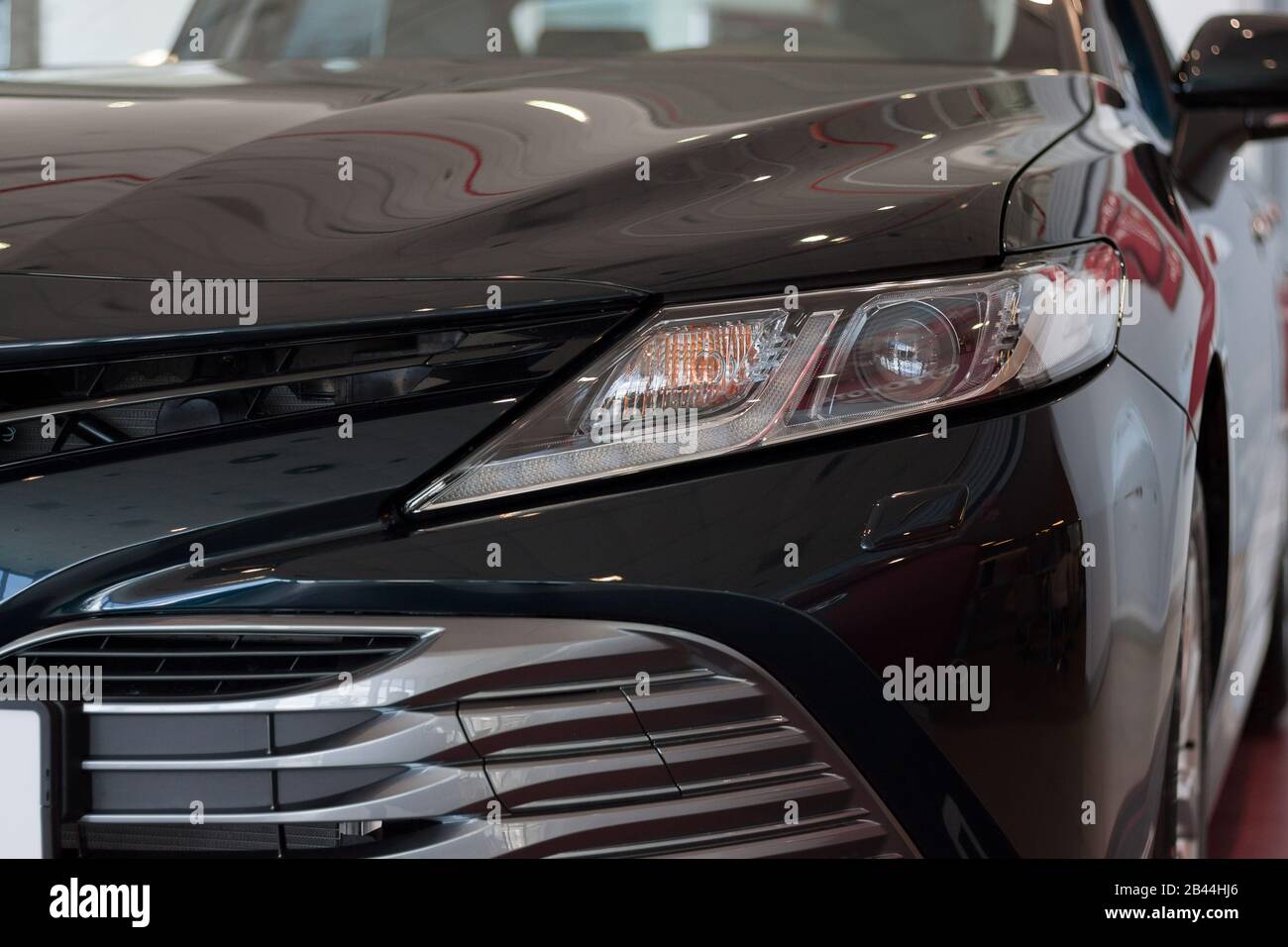 New modern vehicle in showroom. Front view. Stock Photo