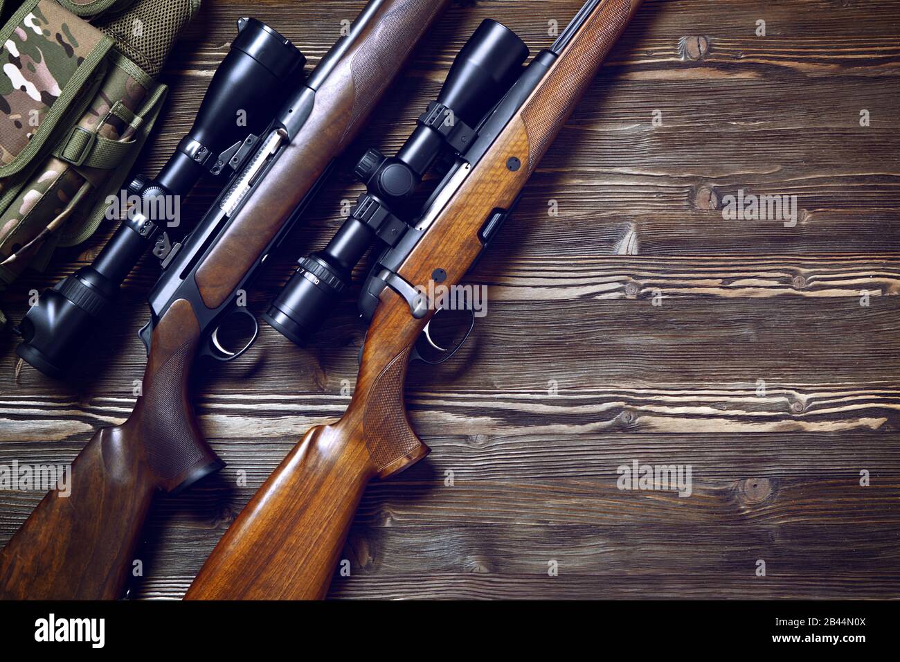 Hunting rifle and ammunition on a dark wooden background.Top view., Hunting  rifle and ammunition on a dark wooden background.Top view Stock Photo -  Alamy