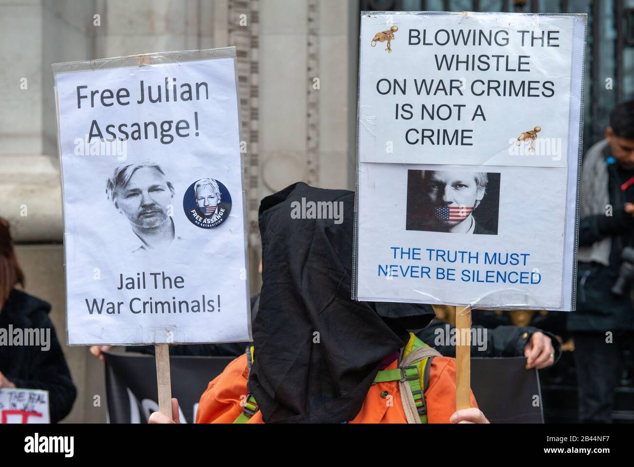 Protester with banner at the Don't Extradite Assange rally in The Strand, in protest of WikiLeaks founder Julian Assange's extradition to the USA. Stock Photo
