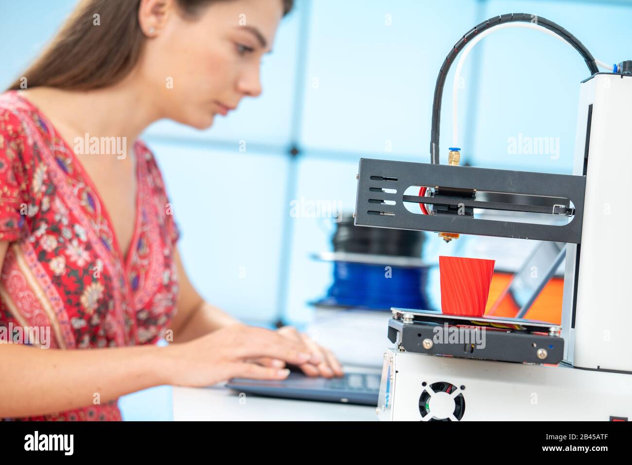 Young female designer works with a home 3D printer Stock Photo