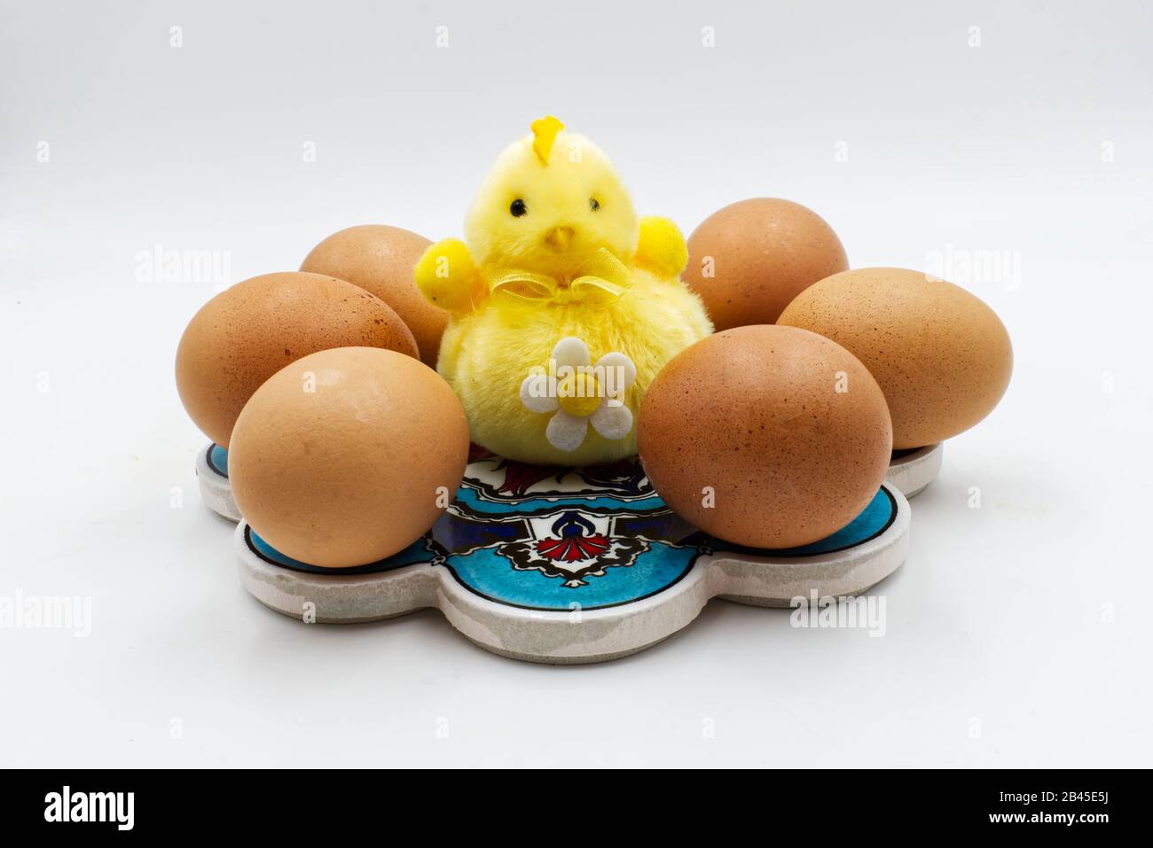 Easter yellow chick with eggs isolated on white background. Easter decoration Stock Photo