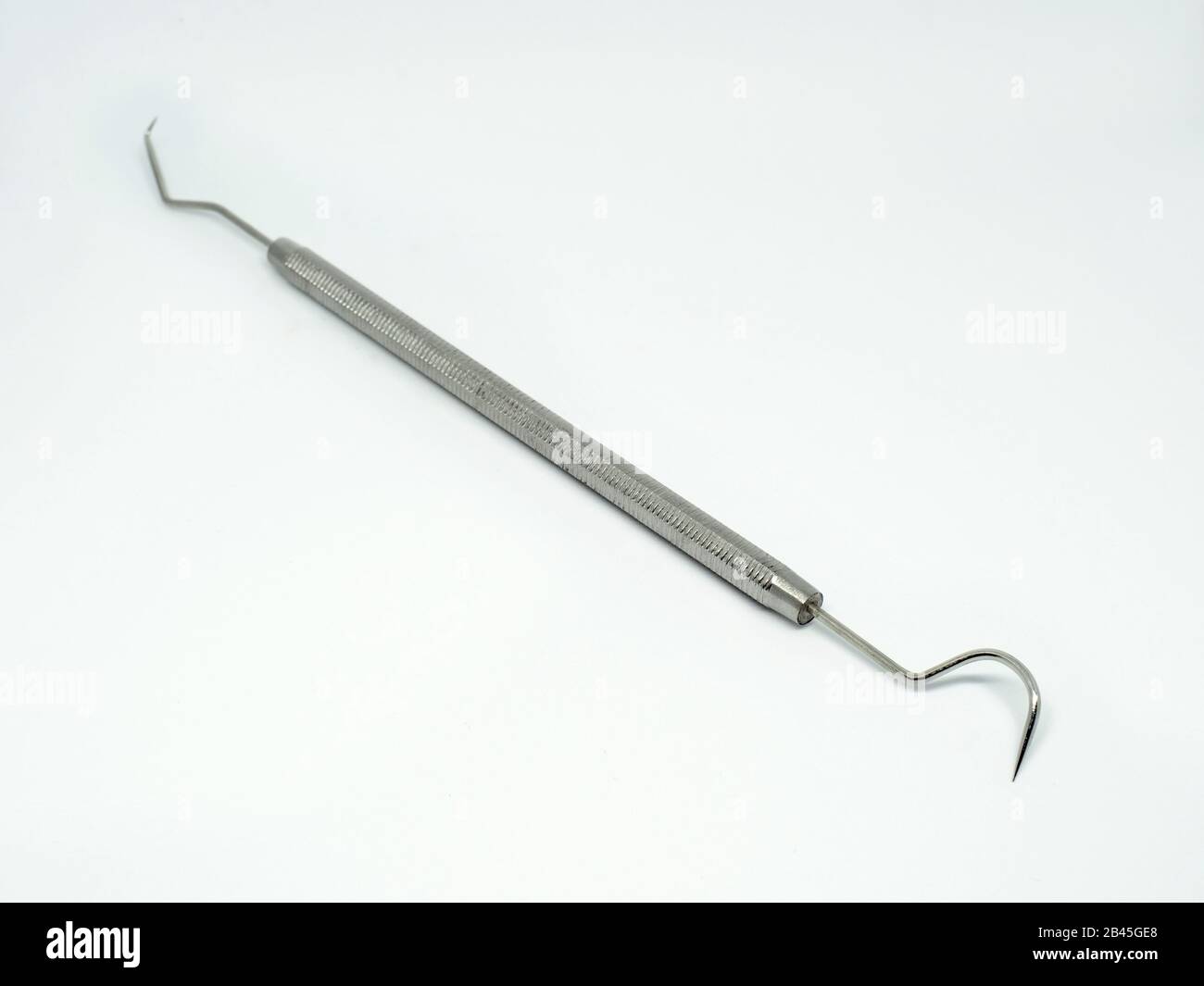 Dental sharp hook instrument on white background angled view. oral