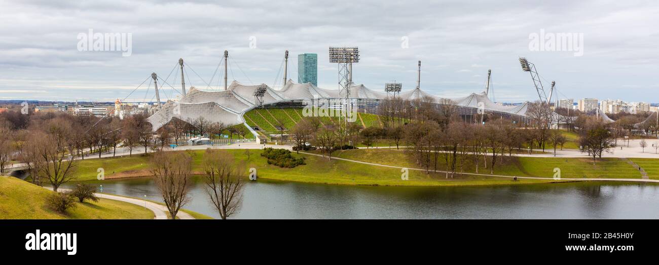 Panorama of Olympiapark with Olympiastadion (Olympic Stadium). The stadium was opened in 1972 and designed by Behnisch & Partner. Tourist destination. Stock Photo
