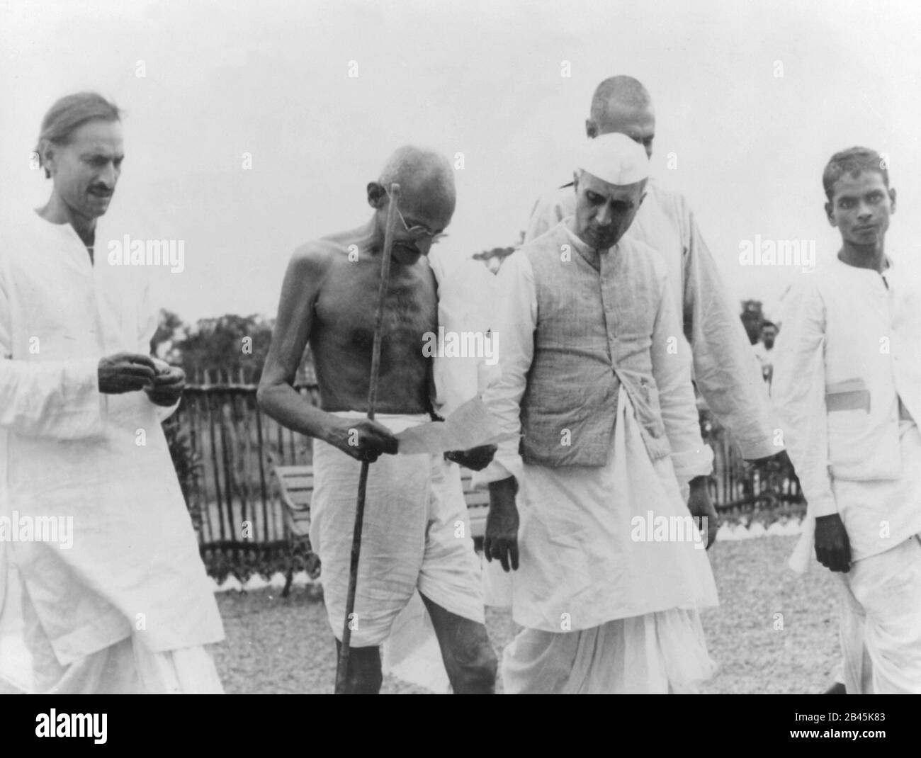 Mahatma Gandhi and Jawaharlal Nehru walking with coworkers, India, 1940s, old vintage 1900s picture Stock Photo