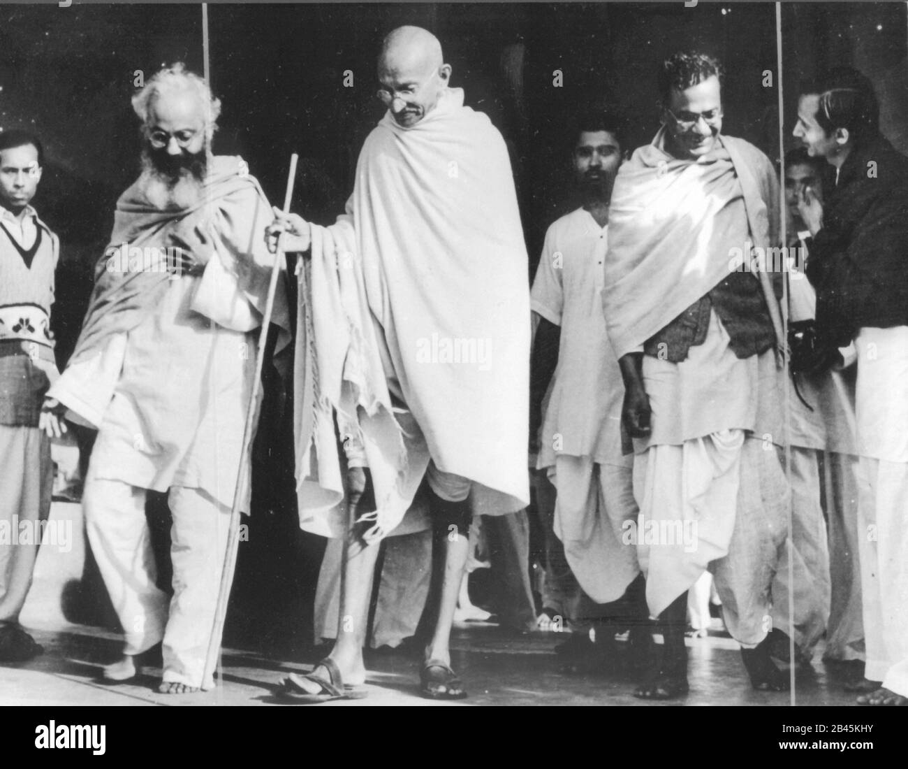 Mahatma Gandhi walking with walking stick with associates, India, 1940s ...