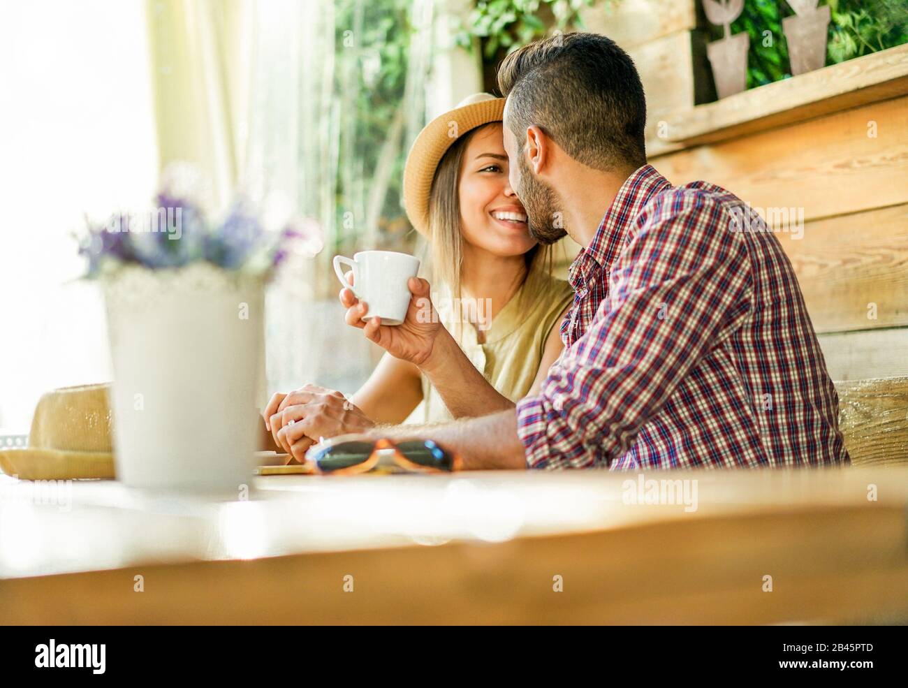 Happy couple toasting coffee and cappuccino at bar restaurant cafeteria