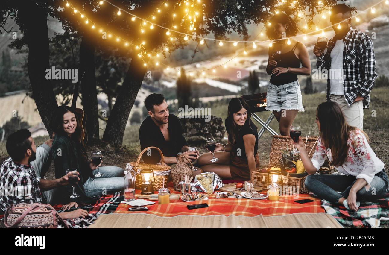 Happy Friends Having Fun At Bbq Dinner With Vintage Lights Outdoor Drinking Wine Young People Celebrating On Weekend Summer Night Friendship Part Stock Photo Alamy