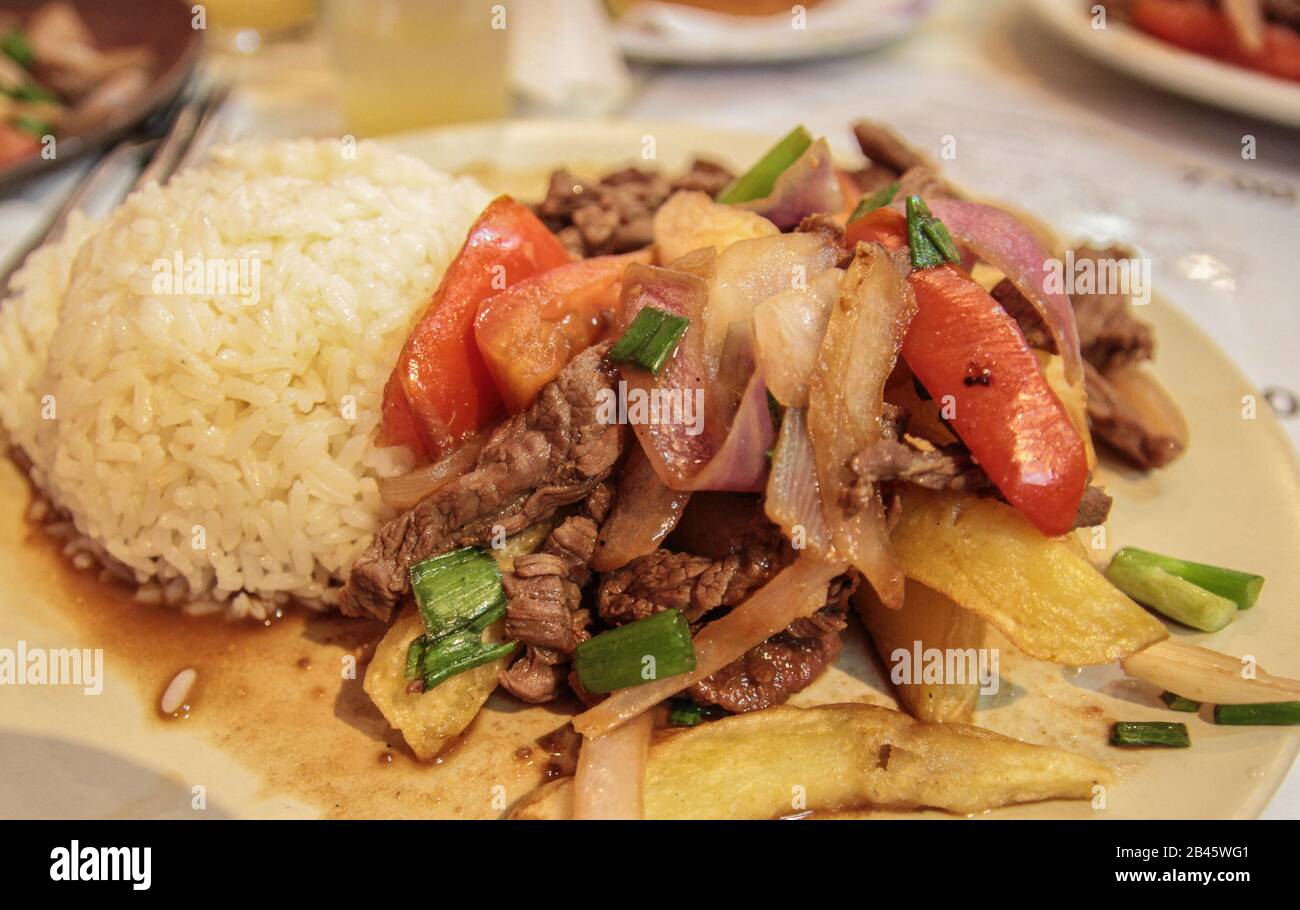 Lomo saltado, a famous traditional dish of South America, especially Peru, containing tomato, onions and beef Stock Photo