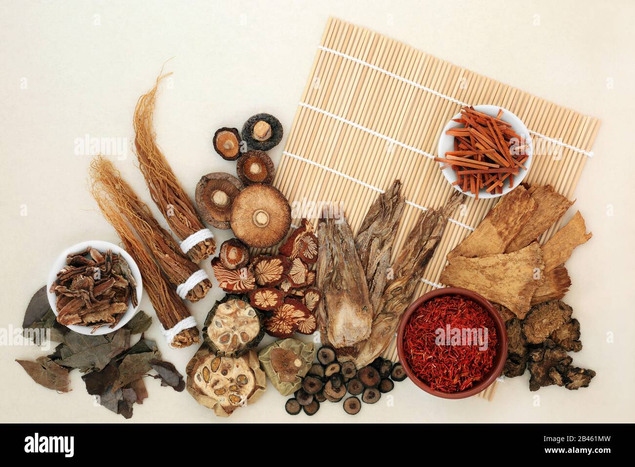 Chinese herb and spice collection used in traditional herbal medicine on bamboo mat and mottled