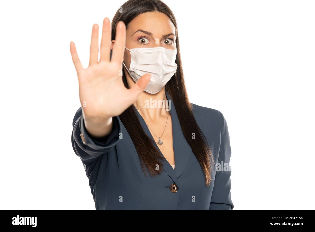 Shocked woman with stop hand and protective mask on her face on white ...