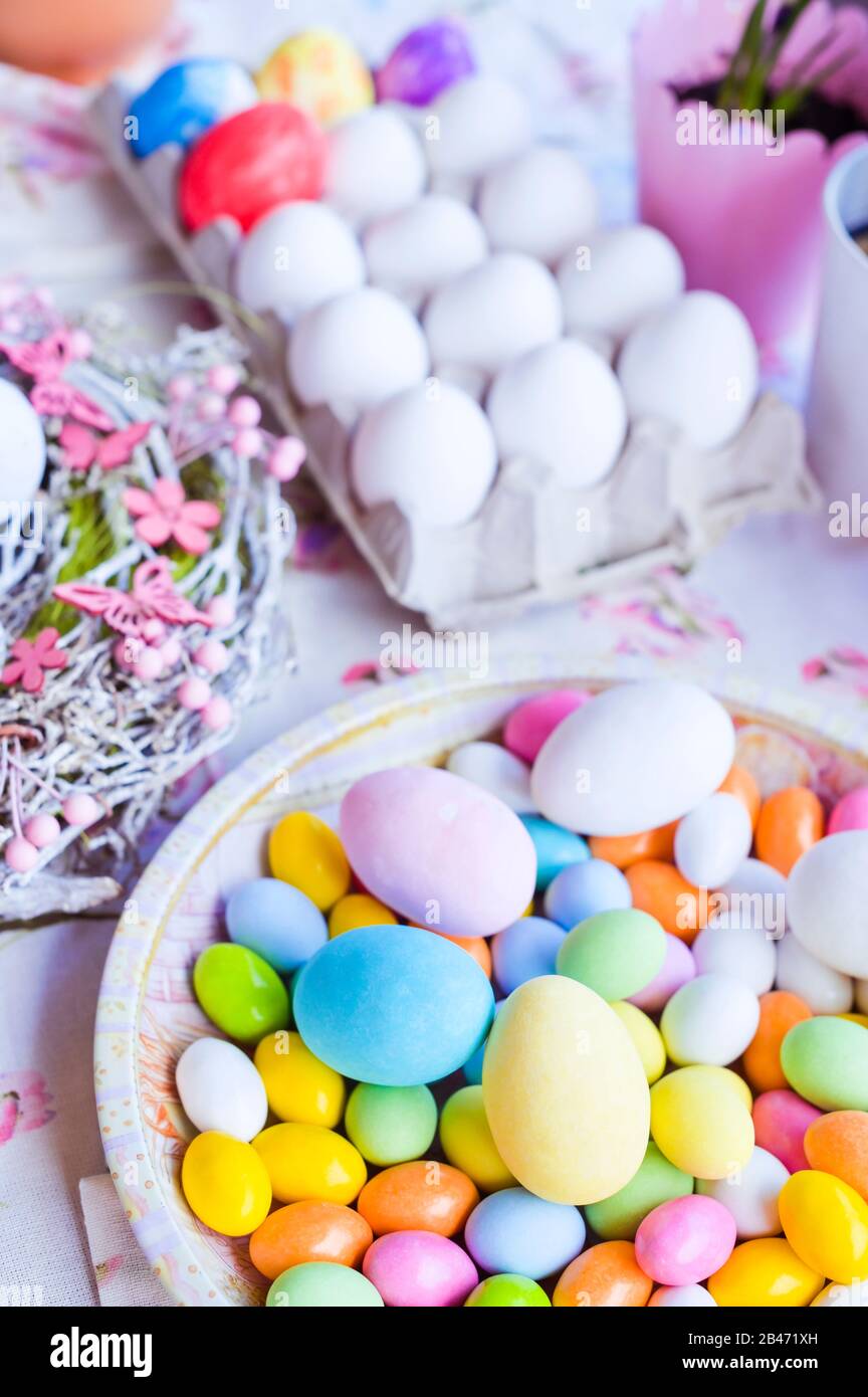 Bright colored eggs, large and small for Easter Sunday. Traditional treats. Copy space. Vertical ...