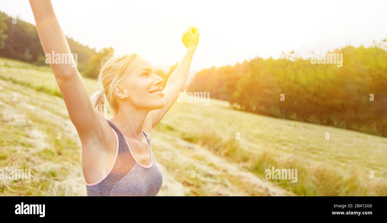 Young woman finds relaxation and freedom in nature while doing sports Stock Photo