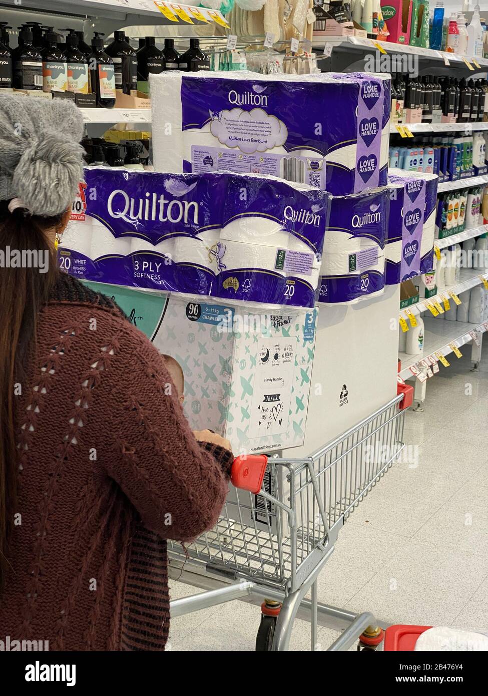 Narre Warren, Victoria Australia - March 6th 2020 -A lady pushing a trolley in a supermarket filled with toilet paper, tissues and baby nappies, panic buying because of the covid corona virus pandemic Credit: Sarah Richardson/Alamy Live News Stock Photo