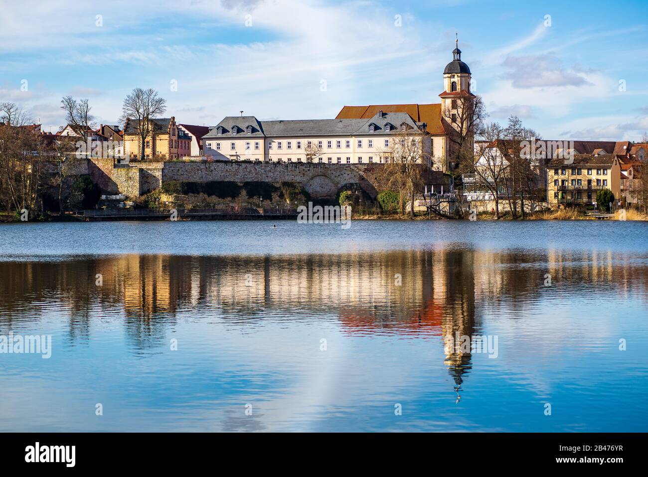 Scenic view of houses by a lake with city walls in the background Stock ...