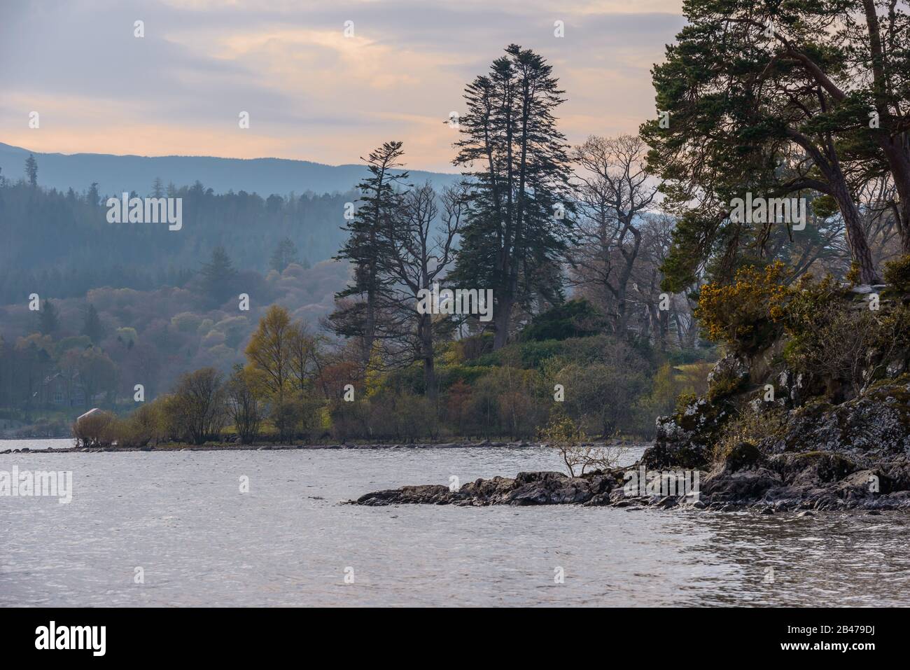 Friars Crag and Derwent Island viewed from Strandshag Bay, Keswick, Lake District National Park, Cumbria, UK, on a hazy April evening. Stock Photo