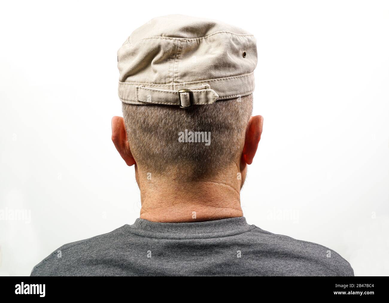 A middle-aged man turned from the back with his Hat Stock Photo