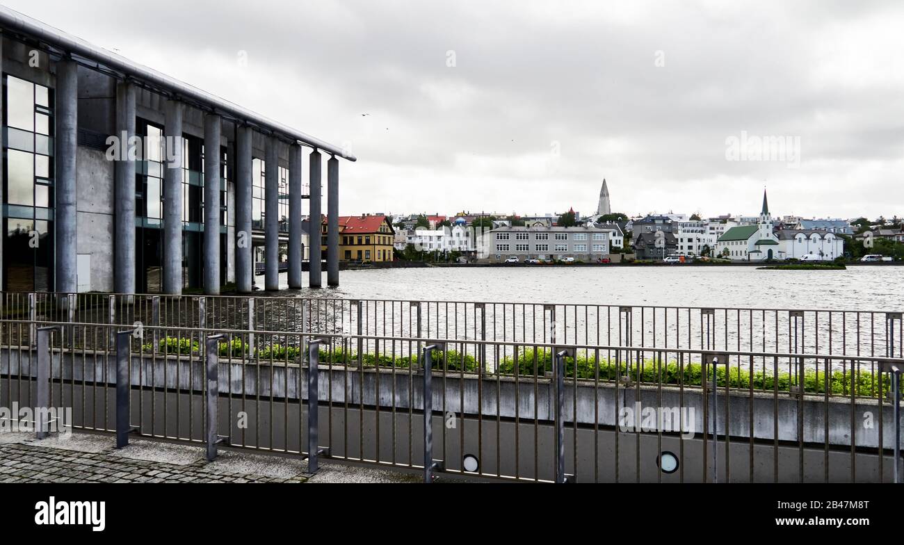 Europe ,Iceland , Actual landscape from Reykjavik city from Tjörnin lake side and shore, we see various buildings including, Reykjavik City Hall, The lakeside city hall Stock Photo