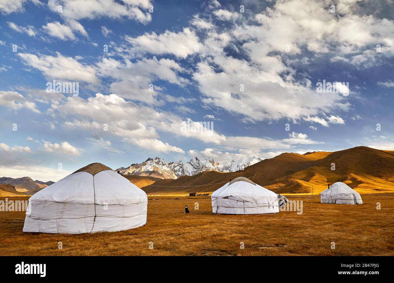 Yurt nomadic houses camp at mountain valley in Central Asia Stock Photo