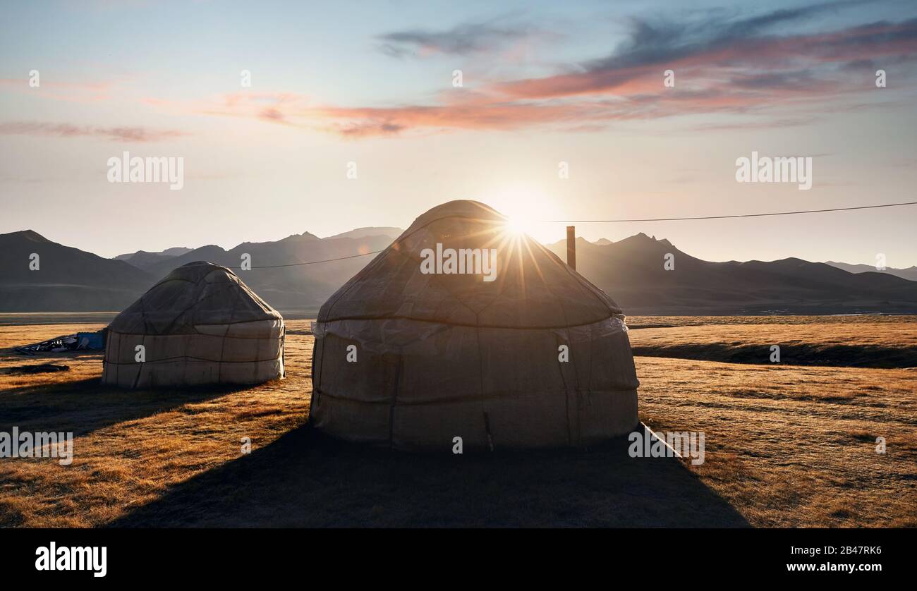 Yurt nomadic houses camp at mountain valley at sunrise in Central Asia Stock Photo