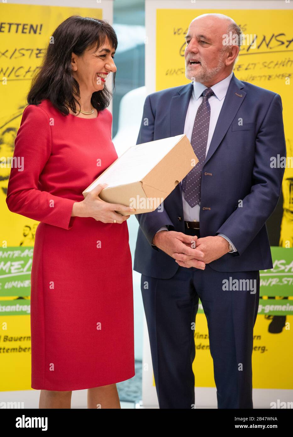 06 March 2020, Baden-Wuerttemberg, Stuttgart: Muhterem Aras (l, Bündnis 90/Die Grünen), President of the State Parliament, receives the petition for a referendum 'Protecting our environment together in Baden-Württemberg' from Werner Räpple, President of the Baden Agricultural Association (BLHV). The farmers' associations collected around 90,000 signatures for their petition in response to the petition for a referendum on greater species protection. Photo: Christoph Schmidt/dpa Stock Photo