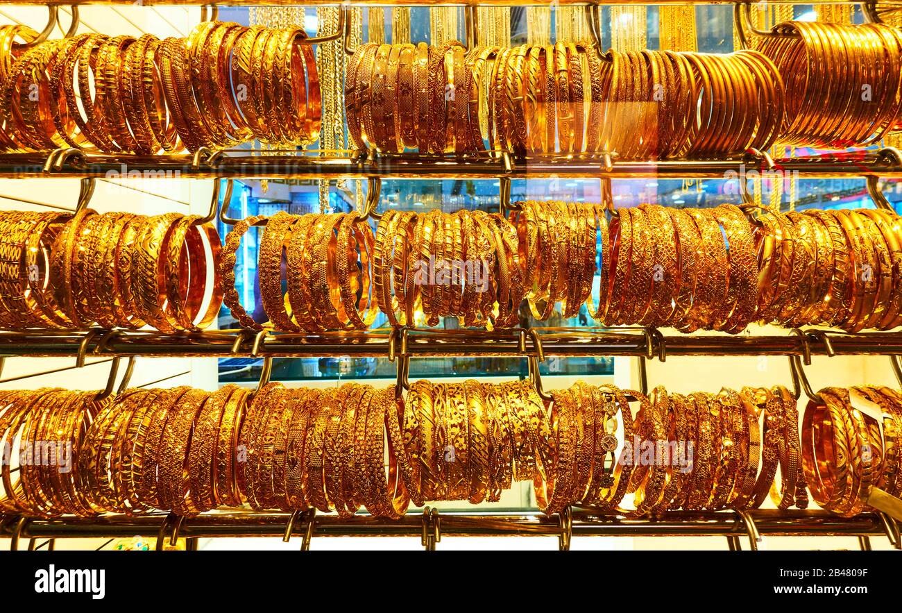 Shop window of a jewelery store with golden bracelets in on the Golden Souk market in Dubai, UAE Stock Photo