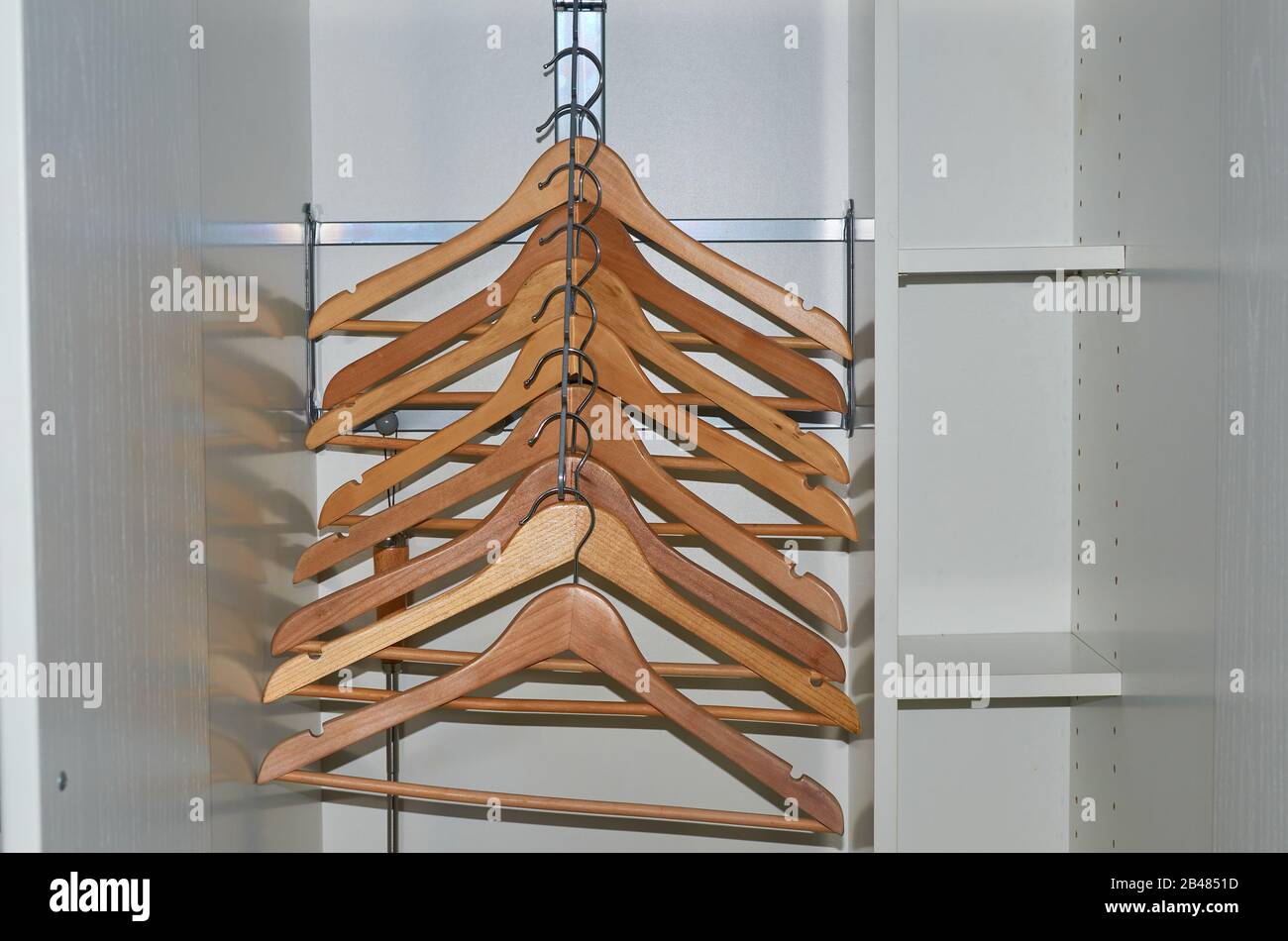 Wooden cloth hangers without clothes in a wardrobe Stock Photo Alamy