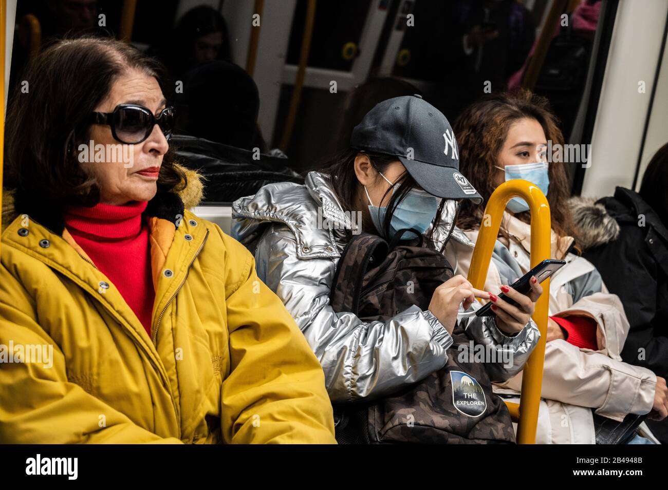 Madrid, Spain. 06th Mar, 2020. Madrid, Spain. March 6, 2020. A couple of asian tourists wearing masks probably to prevent infection of the coronavirus (Covid-19) seen in the subway. Spain has reported to date 5 deaths and 345 infected by the coronavirus. Credit: Marcos del Mazo/Alamy Live News Stock Photo