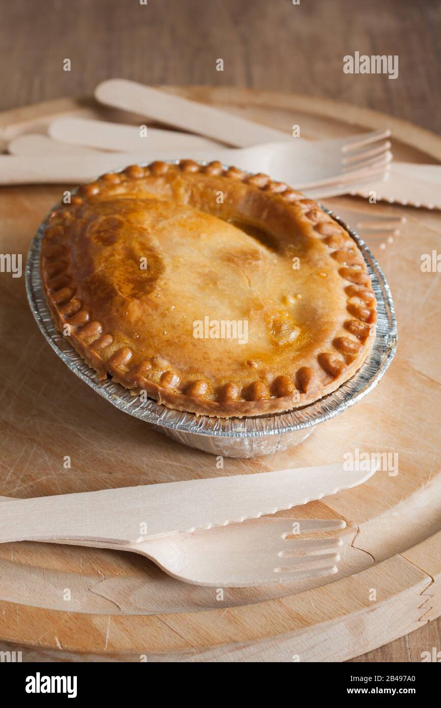 Savoury meat or steak pie with a golden oven baked crust top down view Stock Photo