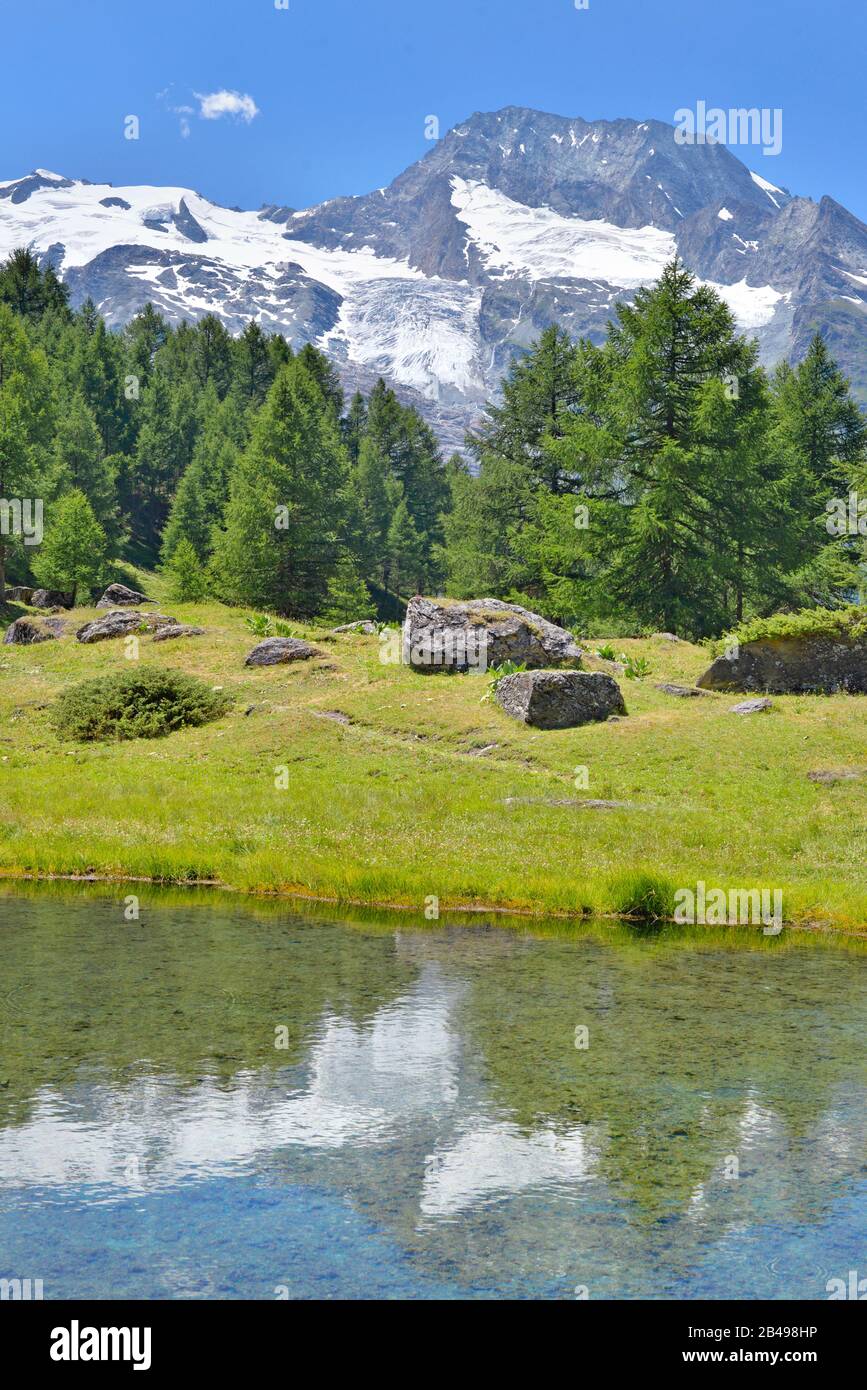 scenery landscape in alpine mountain with a lake and reflection in ...